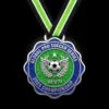 A glittery soccer medal featuring the letters "MVP" prominently displayed on its surface.