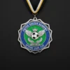 A shiny medal featuring a soccer ball design, symbolizing achievement in soccer.