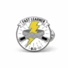 Yellow enamel pin featuring the phrase "fast learner," symbolizing achievement and growth.