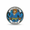 Badge featuring a bear in a blue and white uniform, adorned with a yellow belt pin.