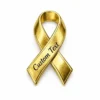 Gold awareness ribbon pin with custom engraved text, polished metal finish for childhood cancer awareness and charity events.