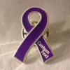 Close-up of a purple awareness ribbon enamel pin with silver edge and custom text, symbolizing cancer awareness and support.