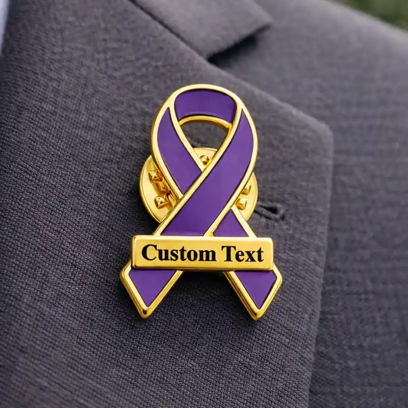 Purple awareness ribbon pin with gold trim and custom text plate, enamel lapel pin worn on a suit jacket for cancer awareness and social causes.