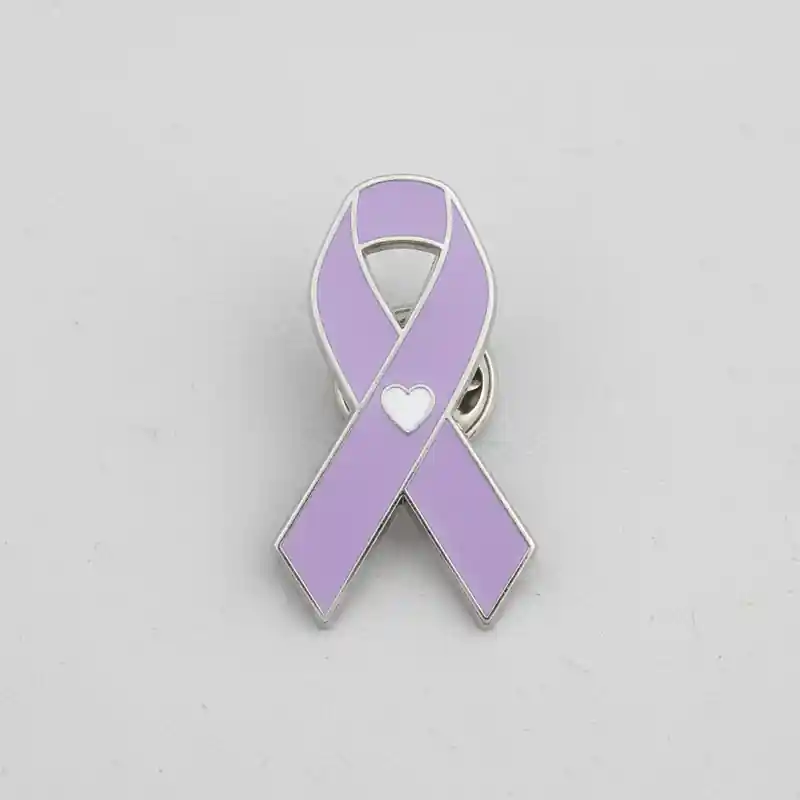Purple awareness ribbon pin with a white heart symbol, enamel finish, used for cancer awareness and social cause support.