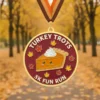 Medal with a turkey pie illustration, commemorating the Turkey Trots 5K event.