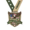 Veterans 5K medal featuring the phrases "Honor, Duty, and Courage" engraved on its surface.
