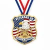 Medal for Veterans 5K featuring the words "Veterans Run," "Service," and "Safety" engraved on its surface.
