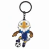 A cartoon eagle mascot wearing a blue soccer jersey with the number 2, kicking a soccer ball, attached to a keychain.