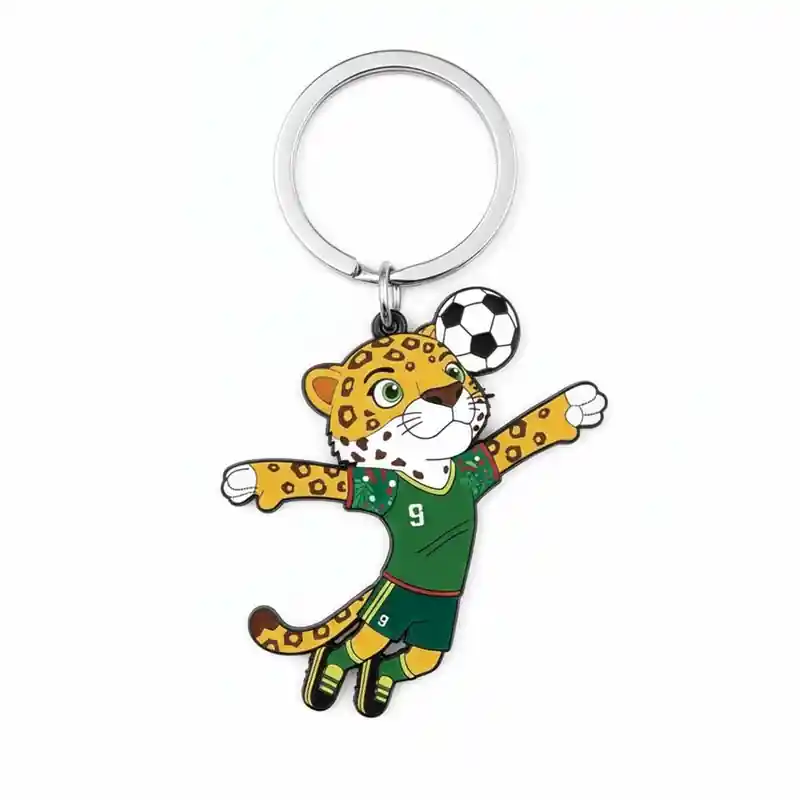 A cartoon leopard mascot wearing a green soccer jersey with the number 9, jumping to catch a soccer ball, attached to a keychain.