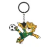 A cartoon leopard mascot wearing a green soccer jersey with the number 9, celebrating with raised arms and a soccer ball attached to a keychain.