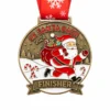 A bronze medal featuring Santa Claus running with a bag full of gifts, candy canes, and a snowy landscape, with the inscription "5K SANTA DASH 2024" and "FINISHER" at the bottom, along with a red ribbon adorned with snowflakes.
