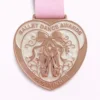 A rose gold ballet dance award medal shaped like a heart, featuring ballet shoes tied with a ribbon and floral accents. The inscription reads "BALLET DANCE AWARDS" at the top and "2025 WINNER" at the bottom.