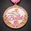 A beautiful Ballet medal featuring a pink ballerina in mid-pose, surrounded by pink roses and ballet slippers, with the word "Ballet" in elegant pink script, all set against a soft pink background.