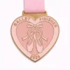 A charming heart-shaped ballet medal featuring a pair of ballet slippers tied with a ribbon in the center, with the word "Ballet" on the top and "FINISHER" at the bottom, accompanied by the year "2025" engraved.