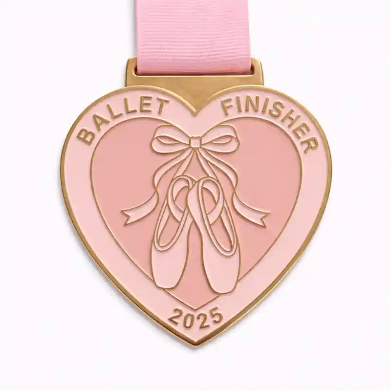 A charming heart-shaped ballet medal featuring a pair of ballet slippers tied with a ribbon in the center, with the word "Ballet" on the top and "FINISHER" at the bottom, accompanied by the year "2025" engraved.