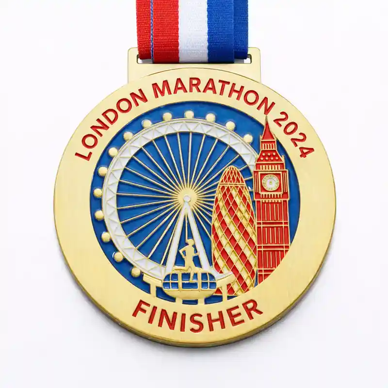 A gold medal featuring the London Eye, Big Ben, and the Gherkin building with the inscription "LONDON MARATHON 2024" and "FINISHER" at the bottom, along with a red, white, and blue ribbon attached.