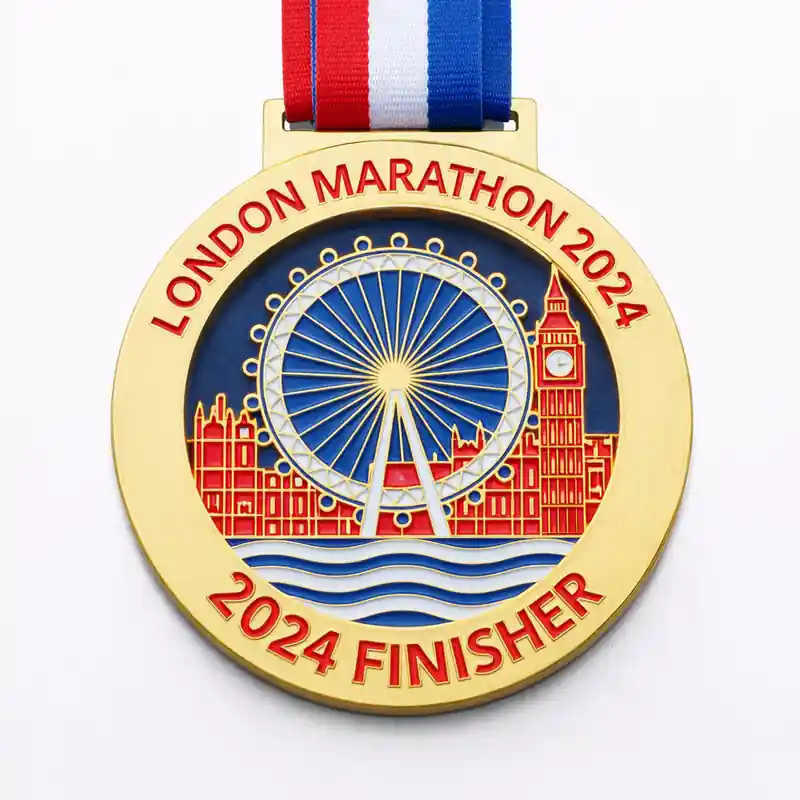 A gold medal featuring the London Eye and Big Ben with the inscription "LONDON MARATHON 2024" and "2024 FINISHER" at the bottom, along with a red, white, and blue ribbon attached.