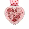 A silver heart-shaped medal featuring red and pink roses with the inscription "FOREVER & ALWAYS" and "MY ONE AND ONLY," along with a pink ribbon adorned with heart patterns.