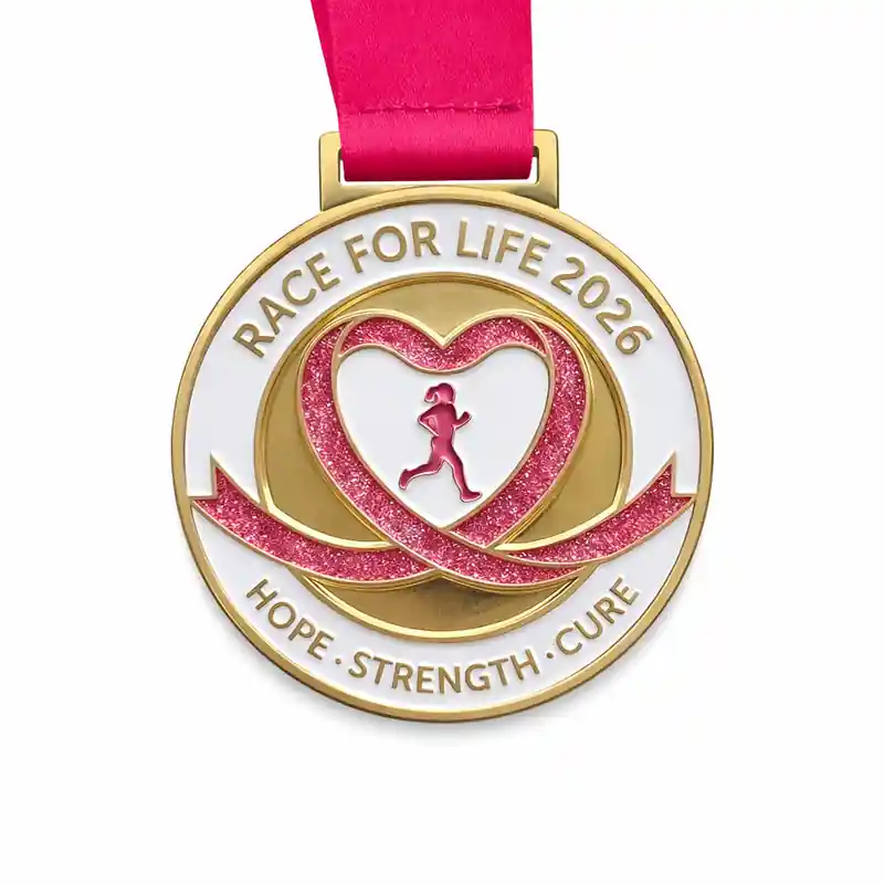 A round medal with a pink glittery heart and a running silhouette inside. The heart is surrounded by a ribbon that reads "HOPE · STRENGTH · CURE" at the bottom. The top of the medal reads "RACE FOR LIFE 2026."