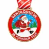 A colorful medal featuring Santa Claus running with a bag full of gifts in a snowy landscape, with the inscription "SANTA DASH 5K" and "5K FINISHER 2026" at the bottom, along with a red ribbon adorned with snowflakes.