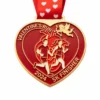 A heart-shaped red medal featuring a couple of runners, Cupid flying above, and the inscription "VALENTINE'S RUN 2024 5K FINISHER" with a red ribbon adorned with heart patterns.