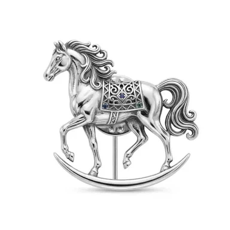 Silver rocking horse lapel pin with ornate saddle details and a classic vintage design.