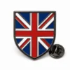 Shield flag Union Jack pin with black nickel outlines, red white and blue enamel flag pattern, shield badge shape, and a butterfly clutch on white.