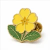 Yellow Primrose Pin soft enamel pin with raised metal outlines, flat enamel color sections, connected badge details, and a butterfly clutch on a white background.