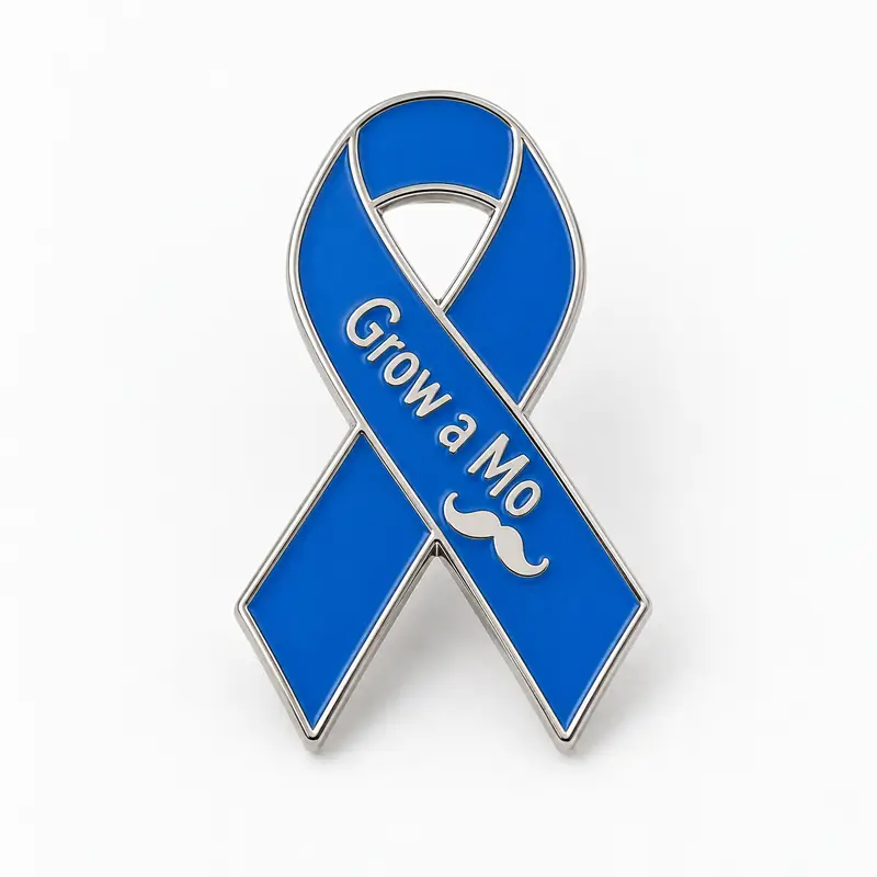 A custom blue awareness ribbon enamel pin with polished silver-tone outlines, raised “Grow a Mo” lettering, and a small mustache symbol.
