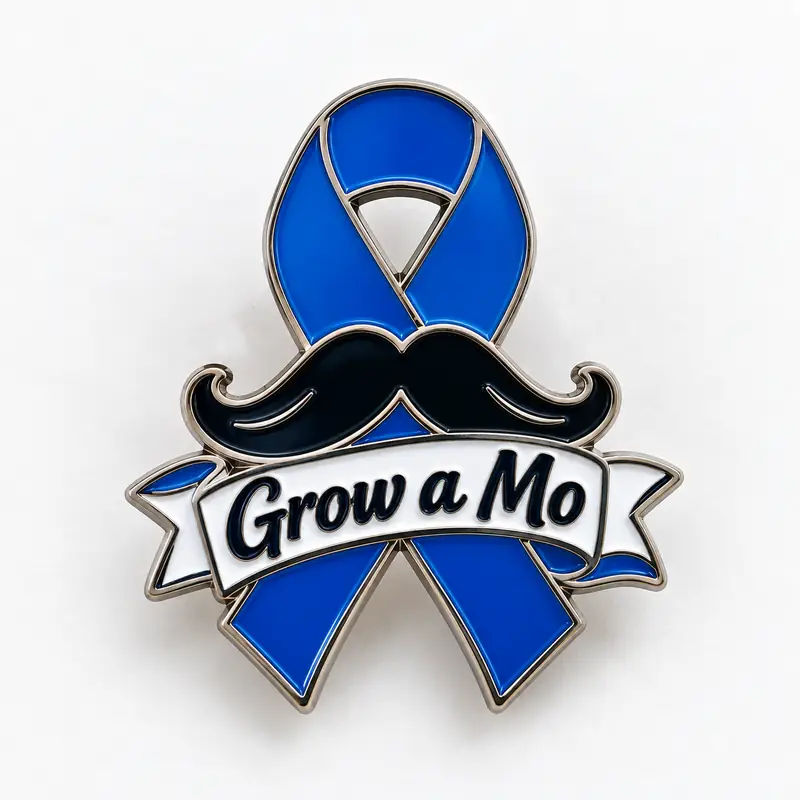 A custom blue awareness ribbon enamel pin featuring a large black mustache, white banner with “Grow a Mo” lettering, and polished silver-tone metal outlines.